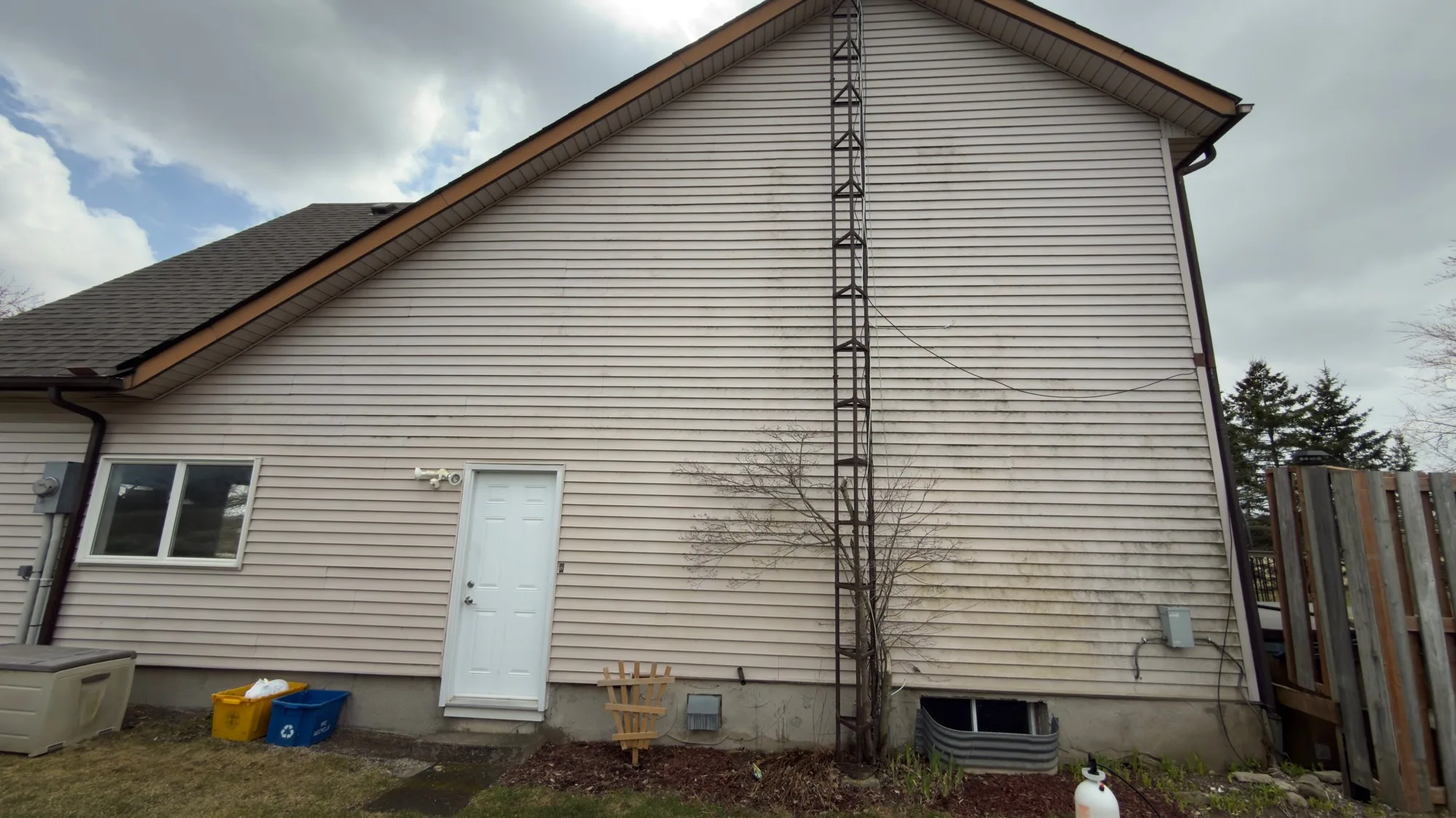 Wide gable view of algae-streaked vinyl siding before D&D Home Services soft wash treatment in Kitchener-Waterloo