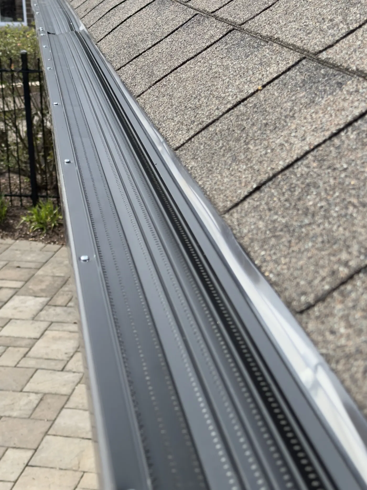 New aluminum gutter guards installed on the same gutter after cleaning in Kitchener